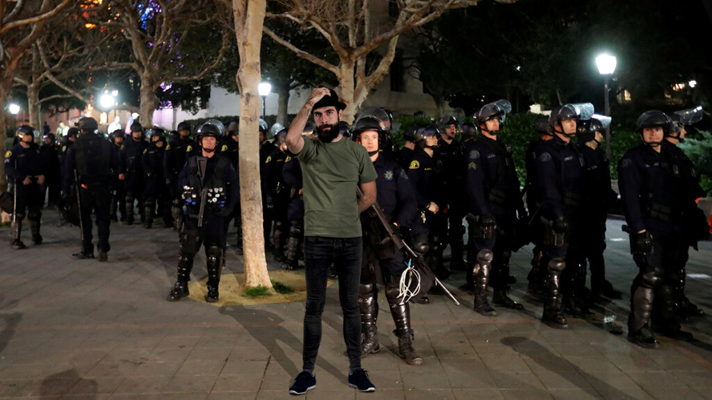 Self-proclaimed postmodern social justice warrior David "Riddle Me" Shoreston seen here trying to disrupt fascist police officers with his trademark skinny jeans and fedora.